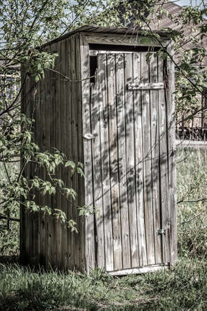 Rustic toilet made of boards on the street close-up.の写真素材
