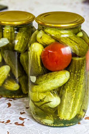 A glass jar with homemade canned cucumbers.の写真素材
