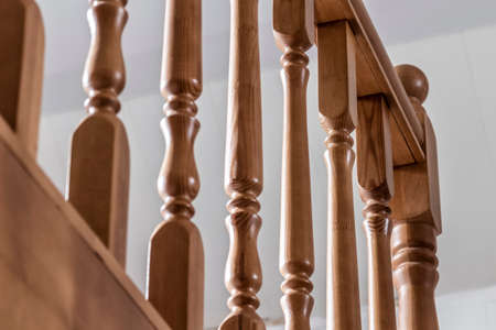 Element of a wooden interior staircase. Wooden baluster close-up.の写真素材
