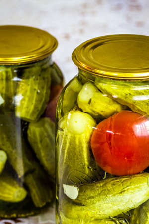 A glass jar with homemade canned cucumbers.の写真素材