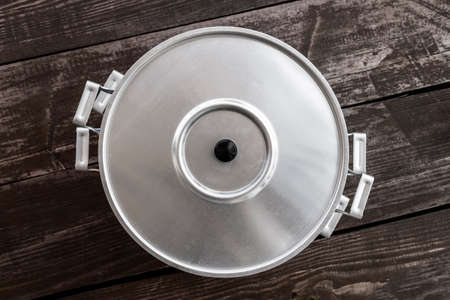 White aluminum steamer on a wooden rustic table.の写真素材