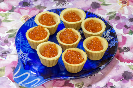 Red caviar in waffle cups on the table close-up.の写真素材