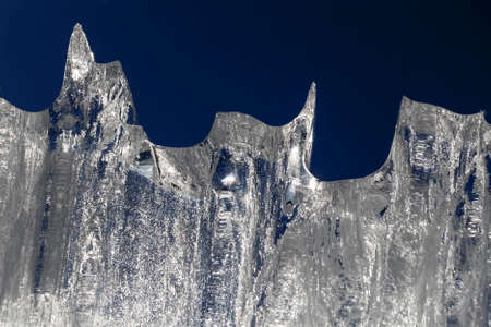 Abstract shapes from ice on a background of blue sky.の写真素材
