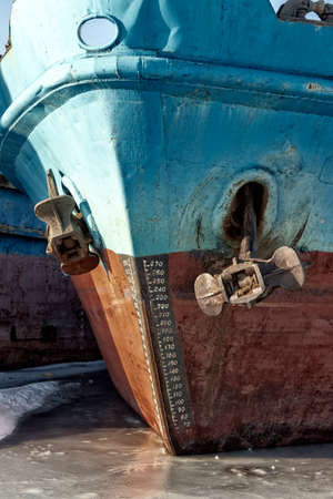 Cargo ships are in a shipyard frozen into the ice.の写真素材