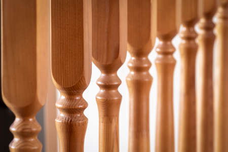 Element of a wooden interior staircase. Wooden baluster close-up.の写真素材