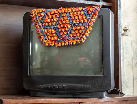 The old picture tube TV is covered with a cape.の写真素材
