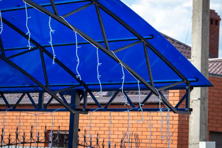 Blue polycarbonate canopy in the backyard of a private house.の写真素材
