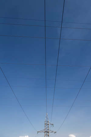 High voltage electrical lines and equipment against the blue sky.