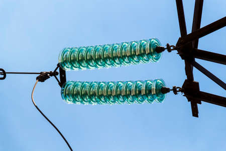 High voltage electrical lines and equipment against the blue sky.の写真素材