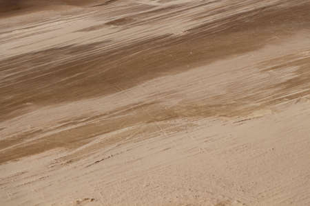 Traces of a car on the sandy river bank.