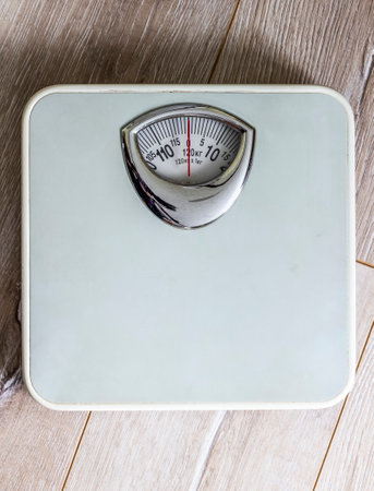 Weighing scales are on the floor in the hallway.の写真素材