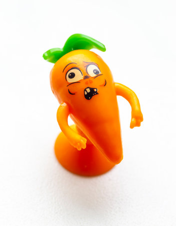 Small figurine of carrots on a white background close-up.の写真素材
