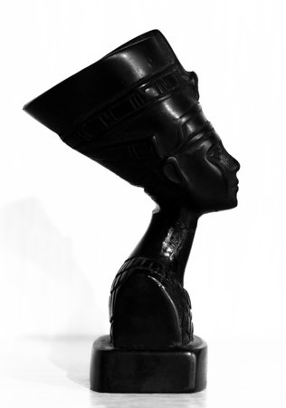 Black statuette of Nefertiti on a white background close-up.の写真素材