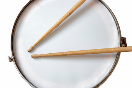 Red snare drum and wooden drumsticks.