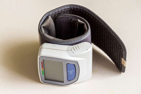 Close-up of a compact wrist blood pressure meter.