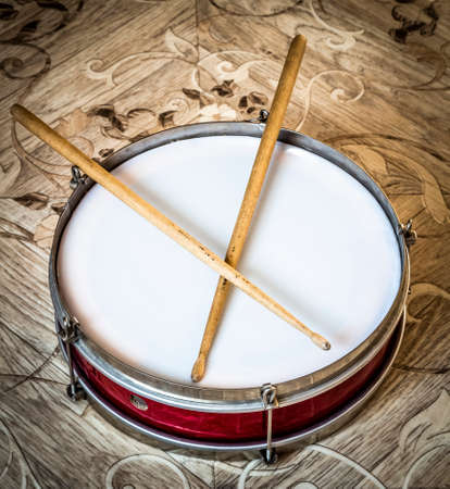 Pioneer red snare drum and wooden drumsticks.の写真素材