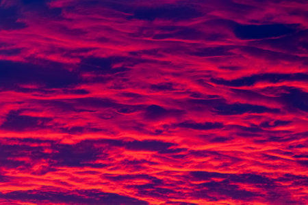 Gorgeous fiery purple evening sunset as background.