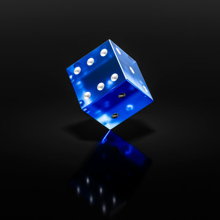 A plastic playing translucent die stands on its edge.の写真素材