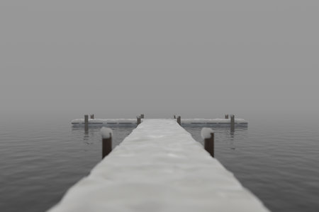 Wooden pier under snow on a quiet foggy winter day.の写真素材