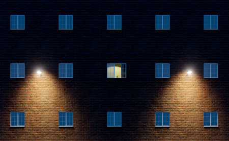 The light is on in one open window of a large multi-story residential building.