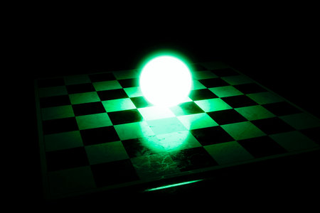 A bright glowing green ball in the center of the chessboard.