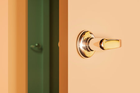 A close-up of the shiny chrome handle of an ajar door.の写真素材