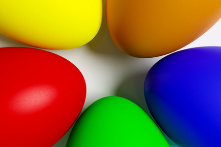 Painted Easter eggs lie on a white ceramic plate.の写真素材
