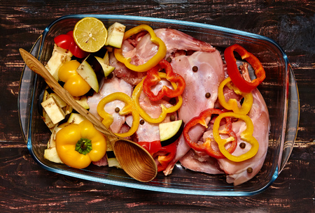 Raw rabbit meat in cooking pan with spices and vegetables. Cooking background.の写真素材