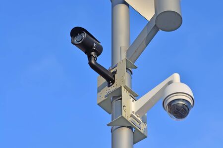Security camera on blue sky background closeup