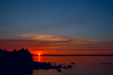 Beautiful view of the colorful sunset on Lake Pongoma, North Karelia, Russiaの写真素材