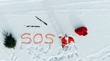 SOS-message of Santa Claus in the snowy open space