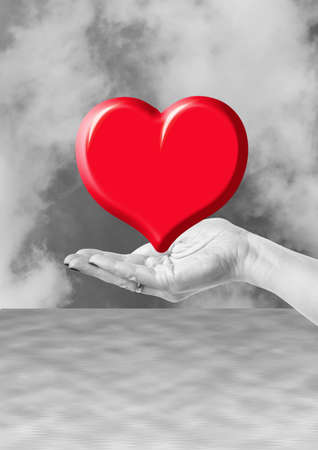 hand holding red heart, love or medical concept on black white backgroundの写真素材