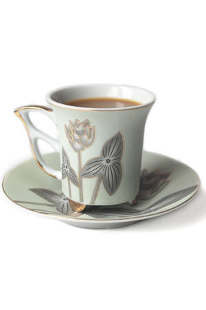 cup of coffee with milk or cream and saucer の写真素材