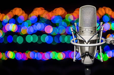 Professional, studio microphone on a background of blurry bokeh lights. Located on the right.
Can be used for audio, karaoke and music content.の写真素材