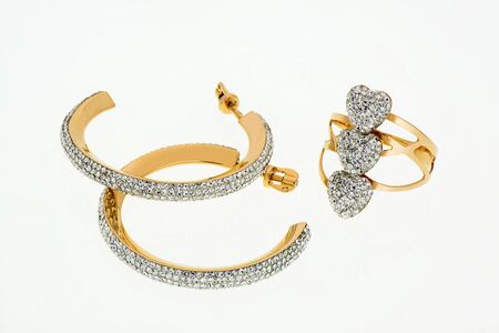 Earrings and ring with white rhinestones with stones. Costume jewelry on a white background. Is isolated.の写真素材