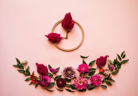 Fresh flowers   lie on a   pink background -  Shape clockの写真素材