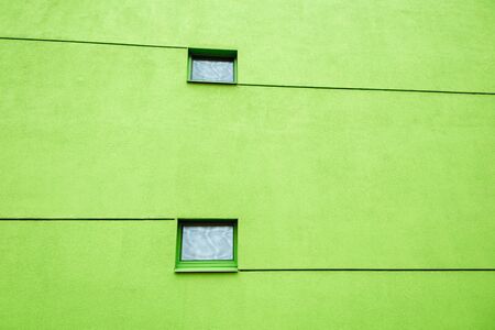 Huge wall on modern building with two windows and lines. Reflections in windows. Copy spaceの写真素材