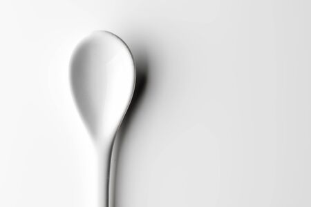 White spoon isolated on a white surfaceの写真素材