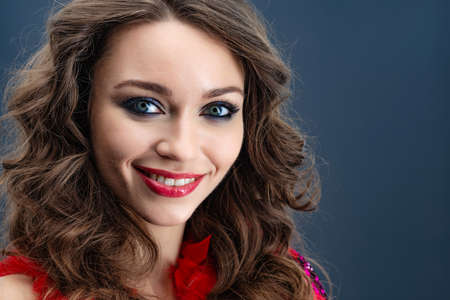 Portrait of enthusiastic beautiful  woman over blue background Ñloseup- Imageの写真素材