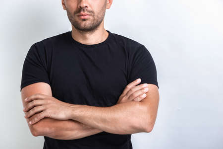 Cropping portrait of serious man folded hands.- Imageの写真素材