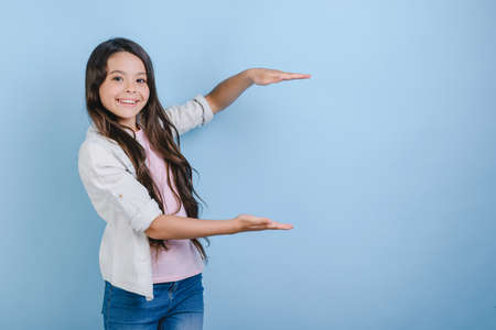 Young little girl holds empty copy space. - Concept imageの写真素材