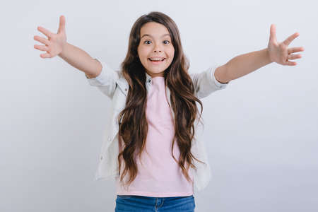 Studio shot of little girl with hands apart. Very happy emotion , - Concept image