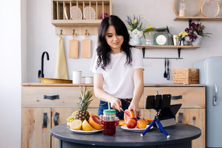 Attractive girl prepares fruit smoothiesの写真素材