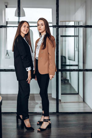 Two attractive business girls posing in work officeの写真素材