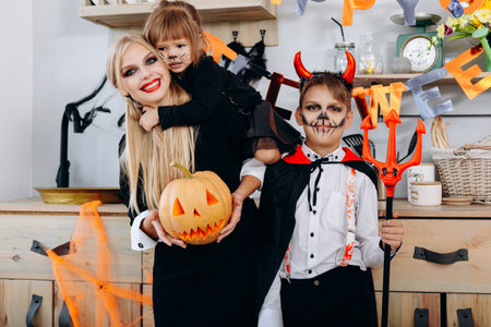 Funny family in the kitchen standing  in fancy dress and looking at the camera - Halloween conceptの写真素材