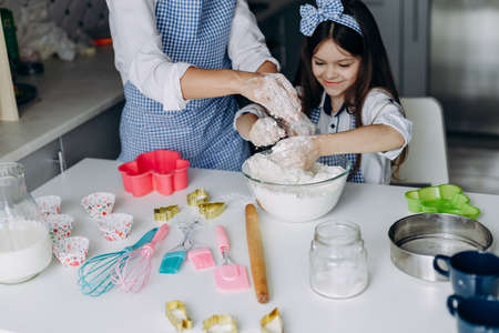 Mother and daughter cooking together in the kitchen. Top view- Imageの写真素材