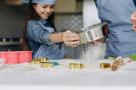 Closeup girl  stir the dough. Focus on a dough- Imageの写真素材