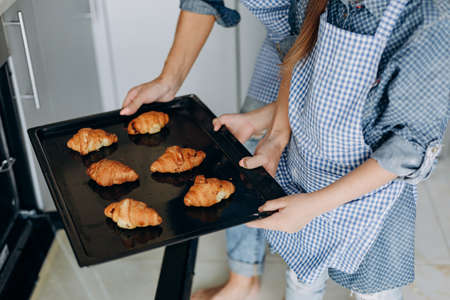 Closeup female hands holding croissants.Family concept- Imageの写真素材