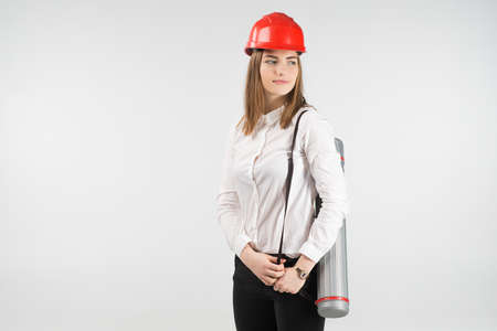 Woman   architect stands with a tube behind her backの写真素材