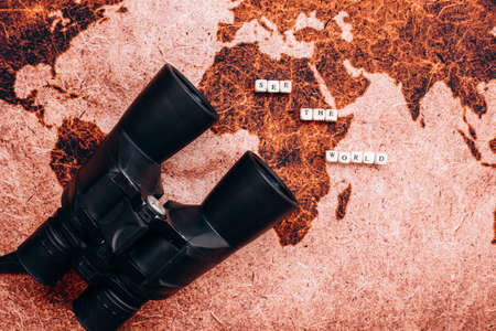 Black binoculars lies on the a geographical map. High quality photoの写真素材